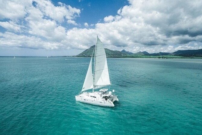 Full Day Shared Tour Catamaran to Ile Aux Cerfs - Setting sail with Mauritian music
